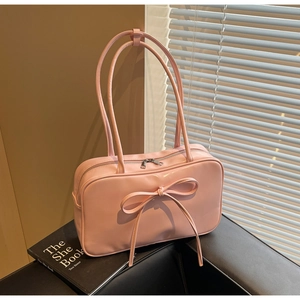 Detail of soft pink tote bag with bow decoration and double zipper closure