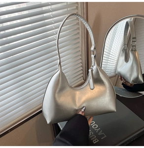 Close-up of metallic silver hobo bag featuring premium faux leather texture and zipper