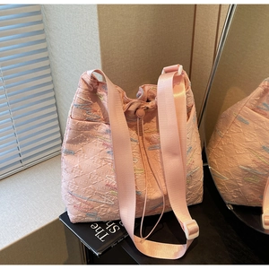 Detailed close-up of pink quilted canvas tote bag with FF monogram pattern and colorful stitching