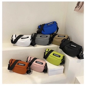 Group shot of colorful nylon saddle bags with wide straps and fashion letter logo