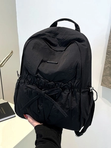 Large black nylon backpack with drawstring bow and minimalist trendy design for women