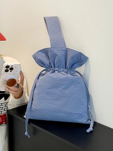 Minimalist light purple nylon drawstring bucket bag with a wide shoulder strap for women