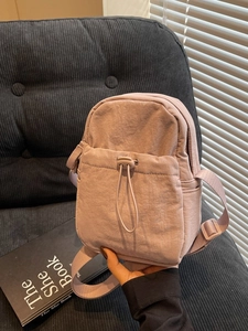 Minimalist lavender nylon crossbody bag with drawstring pocket and adjustable strap
