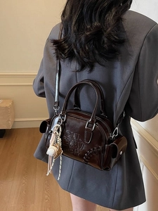 Brown leather Boston shoulder bag with embossed letters and baseball stitching detail