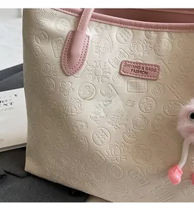 Detailed close-up of beige leather tote with traditional Chinese embossed lotus patterns