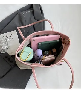 Macro view of spacious textured tote bag interior holding a tablet and umbrella