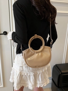 Elegant beige semi-circular handbag with round handle and detachable shoulder strap