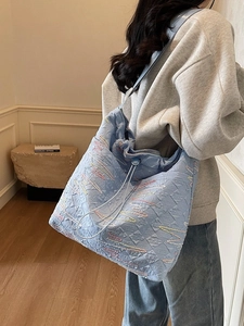 Light blue quilted canvas tote bag with colorful embroidery and large capacity for women