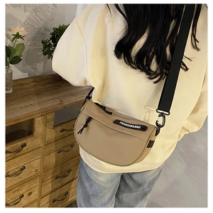 Detail of beige nylon saddle bag with wide adjustable strap and Fashion&Bag logo strap
