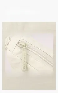 Detail of smooth metal zipper on waterproof oxford fabric bag showing texture