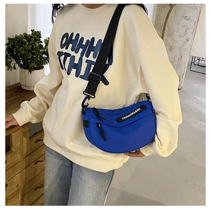 Blue canvas half-moon crossbody bag with adjustable strap and Fashion&Bag logo detail