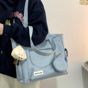 Detail of light blue large capacity tote bag with cute mushroom plush and round coin pouch