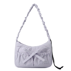 Detailed close-up of lavender nylon tote with decorative bow and gathered shoulder strap