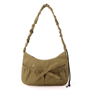 Detail of olive green nylon hobo bag featuring stylish bow tie and ruched shoulder strap