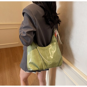 Vue détaillée du sac cabas vert clair en cuir huilé avec pampille et pendentif tissé