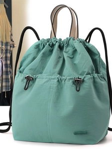 Light mint green nylon backpack with drawstring closure and large front pocket