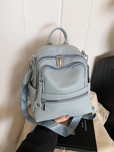 Grey-blue leather backpack with three zipper compartments and wide fabric straps