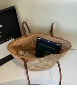 Top view showing large capacity interior of the woven straw tote bag with inner pockets