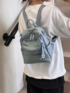 Chic light blue faux leather mini backpack with multiple pockets and silver zippers