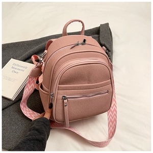Detail of rose pink backpack with woven texture and geometric patterned wide strap