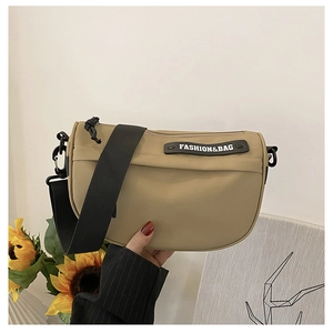 Khaki nylon saddle bag featuring a wide black strap and a Fashion & Bag rubber patch