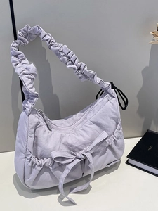 Lilac nylon tote bag with bow detail and ruched shoulder strap in a minimalist design