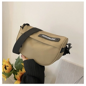 Detail of khaki nylon saddle bag showing the wide strap and Fashion & Bag label