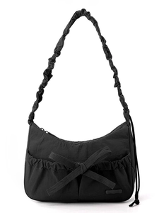 Minimalist black nylon crescent hobo bag with large bow and ruffled shoulder strap