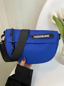 Royal blue nylon half-moon crossbody bag with adjustable wide strap and front logo patch