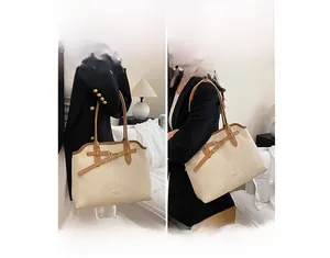 Detail showing beige lychee grain tote bag with brown handles in handheld and shoulder styles