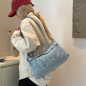 Detail of light blue pleated shoulder bag texture with premium cloud-like fabric