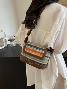 Colorful striped straw crossbody bag with brown faux leather trim for summer vacation