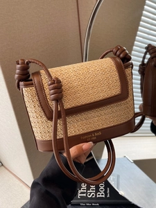 Contrast woven straw crossbody bag with brown leather trim and knotted strap detail