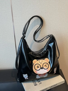 Glossy black tote bag with cute cartoon bear patch and adjustable shoulder strap