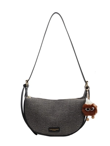 Grey woven crescent shoulder bag with black leather straps and plush toy charm accessory