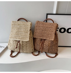 Detail showing two woven straw backpacks in white and brown with leather straps