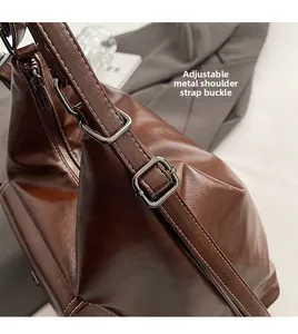 Close-up of brown leather strap with adjustable silver metal buckle and lychee texture