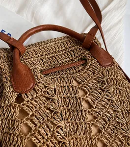 Close-up of handmade straw weaving texture and fine leather stitching on summer backpack