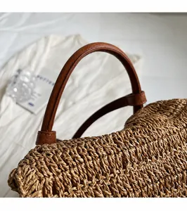 Close-up of durable brown leather handle and intricate straw woven texture of the backpack