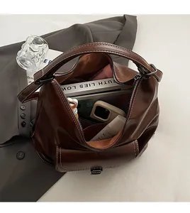 Macro shot showing large storage capacity of the dark brown leather tote bag