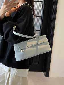 Chic light blue underarm shoulder bag with heart pendant and sleek patent leather finish