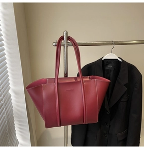 Close-up of vintage burgundy tote bag with white contrast stitching and FASHION logo