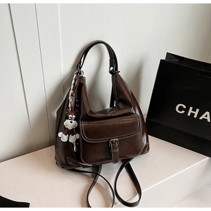 Close-up of vintage dark brown faux leather backpack with white contrast stitching