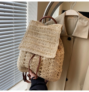 Detail view of woven straw backpack with brown leather drawstring and premium texture