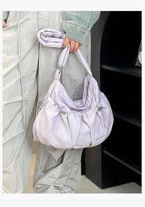 Detail of light purple drawstring nylon tote bag with waterproof texture and metal buckle