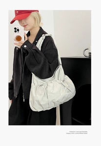Close-up of lightweight nylon tote bag with drawstring texture and wide shoulder strap