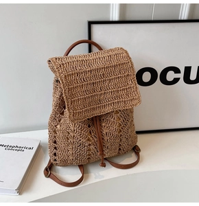 Detailed close-up of woven straw backpack with PU leather drawstring and vintage buckle