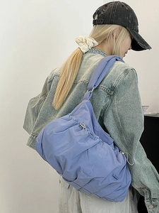Minimalist light purple quilted nylon puffer shoulder bag with adjustable drawstring side