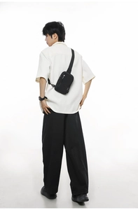 Detail of waterproof nylon crossbody bag showing adjustable strap and buckle closure