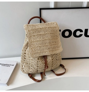 Detail of hand-woven straw backpack showing hollow texture and brown leather trim